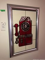 Front view of the decorative mirror showcasing the full framed vintage rotary phone design with a metallic silver frame.