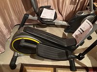 Full view of the Gold's Gym elliptical exercise trainer showing body, pedals, and handlebars.