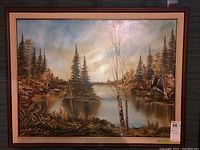 Full frontal view of the framed signed landscape painting showing a scenic lake and pine trees with autumn colors.