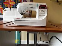 Front view of sewing machine with extension table attached