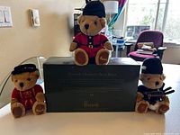 Three Harrods Christmas Character Bean Bears on display with box in the background