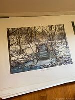 Unframed print of 'Swan Bridge Pond' by N.C. Wyeth showing a creek scene with a wooden bridge and surrounding forest area in autumn colors.