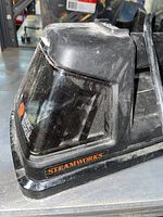 Close-up of Black & Decker Steamworks steamer showing dust accumulated in storage.