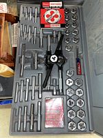 Craftsman 51 pc tap and hexagon die set in plastic case with tools and manual.
