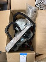 Box containing dryer vent parts, metal paint pans, weather seal strips