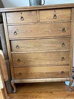 Front view of the 6-drawer solid wood dresser showing drawer layout and metal ring pulls.