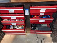 Red tool drawers labeled with contents such as Measuring Devices, Documents, Clamps, Saw Blades, Snap Rings, and More, showing tool storage organization.