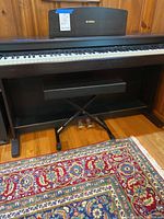 Front view of Yamaha digital piano with bench and pedals