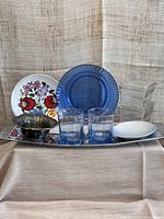 Overall grouping of all lot items including Hungarian floral plate, blue glass plate, two blue lowball glasses, B&G saucer, silver plated bowl, clear glass lidded boxes on a silver platter