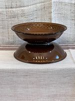 Side view of one of the two brown Cambrian stoneware serving bowls showing shape and color.