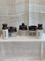Full view of the set of 5 ceramic vintage reproduction tableware items including salt and pepper shakers, sugar and mustard pots, and a storage jar.