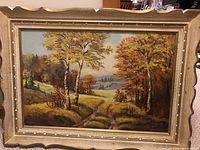 Full view of the framed landscape painting with autumn scene and clear view of the frame.