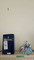 Royal Doulton box and figurine displayed beside each other with a label 'Elysa'.