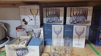 Full view of boxed stemware sets including Marquis Brookside, Pasabahce Diamond, Michelangelo, Crystal Clear, Bohemia Crystal.