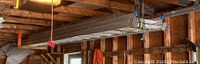 Ladders hanging from ceiling in garage, showing full length and structure.