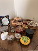Full view of assorted boxes and picture frame placed on wooden surface