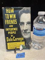 Front cover view with water bottle for scale showing dust jacket portrait of Dale Carnegie