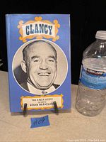 Photo of front cover of the 1968 Clancy hockey book with blue cover and portrait of Clancy.