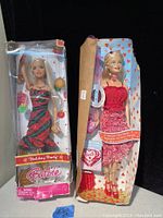 Two vintage Barbie dolls side by side in original packaging; one box is complete, the other is missing the lid and shows wear.