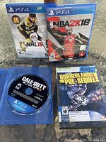 Photo showing three PS4 games (NHL 15, NBA 2K18, Call of Duty: Black Ops III) and one Xbox 360 game (Borderlands: The Pre-Sequel) in cases.
