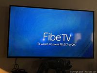 Front view of television powered on displaying Fibe TV prompt