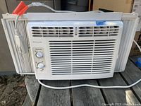 Front view of the white Frigidaire window air conditioner with controls and vent.