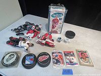 Hockey collectibles including hockey player figurines, team logo pucks, and multiple trading cards.
