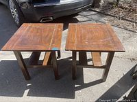 Pair of vintage wood end tables side by side outdoors in daylight, showing overall shape and condition.