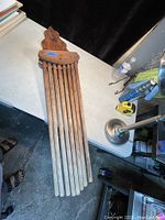 Antique wooden wall mount clothes drying rack laid flat on surface, showing all arms folded.