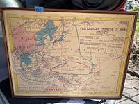 Full view of framed vintage WWII Far Eastern Theatre of War map showing Asia, Alaska, parts of Australia and Pacific Islands with colored regions indicating war zones and alliances.