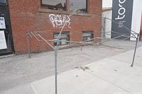 Full metal frame canopy tent set up outdoors showing frame and roof support design.