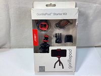 Front view of new sealed Joby GorillaPod Starter Kit 3000-183 showing flexible tripod and various mounts in original plastic packaging.