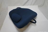 Front and top view of navy blue ObusForme Lowback Backrest Support with attached adjustable lumbar cushion on white background.