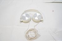 Full view of white Sony over-ear headphones with long attached cable.