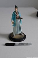 Front view of Saito anime figurine on round base with Sharpie marker for scale.