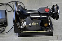 Side profile of Singer Featherweight 221 machine body showing decals