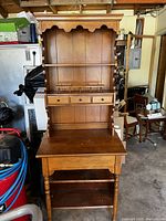 Full view of the wooden secretary desk with hutch showing upper shelves, drawers, and spacious writing desk.