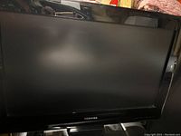 Front view of Toshiba LCD TV, powered off, showing screen and brand logo.