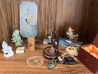 Shelved view of assorted carvings and gift items