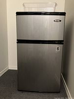 Front view of the Danby mini fridge showing stainless steel finish and two-door layout.