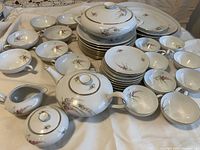 Overhead view of full china set arranged on cloth