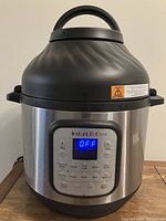 Full view of Instant Pot Duo Crisp + Air Fryer showing body, handles, and lid from the top side.