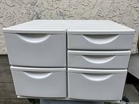 Front view of the white plastic storage chest showing five drawers including two narrow half-height drawers on one side.