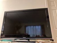 Front view of Toshiba 40" LCD TV powered off showing screen and Toshiba logo on bezel.