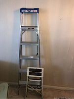 Lite aluminum stepladder with plastic and metal step stools in front