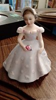 Front view of Royal Doulton The Bridesmaid HN 2196 figurine showing detailed face and front of dress.