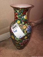 Hand painted oriental style tall vase showing front floral decoration and flared rim