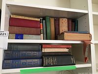 Top shelf grouping of assorted cloth-bound hardcovers