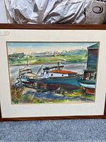Framed watercolor painting of boats docked on shore, full view