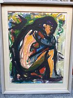 Frontal view of framed watercolour painting depicting abstract seated nude figure